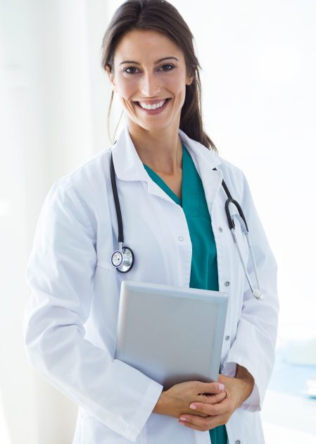 Portrait of beautiful young female doctor looking at camera in the office.